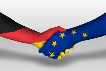 Handshake between european union and germany flags painted on hands, illustration with clipping...