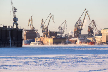 Fototapeta premium Large industrial cranes of the admiralty shipyards in saint petersburg in winter