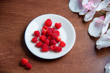 Fresh raspberries on a white plate 