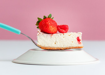 Berries cheesecake bite on a fork