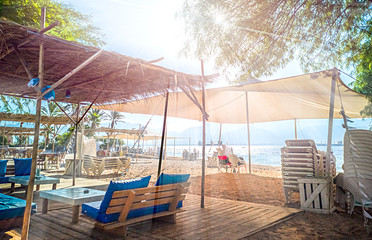 Morning on sandy beach at the Red Sea in Eilat - famous tourist resort and recreation city in Israel and the Middle East