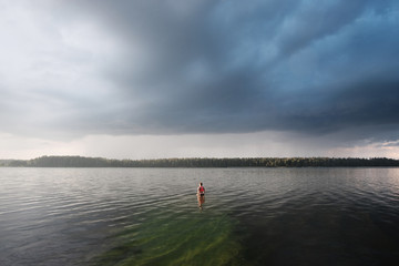 Fototapeta na wymiar Caucasian short hair girl swimming in lake