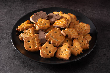 Funny Halloween cookies on black background. 	