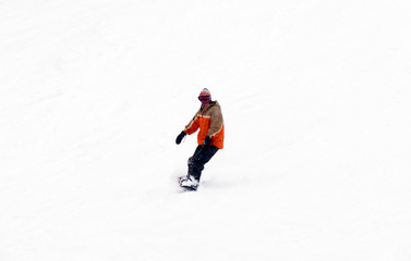 Fototapeta na wymiar FEB 17, 2018 IWATE, JAPAN : Asian snowboarder is riding with snowboard from powder snow hill