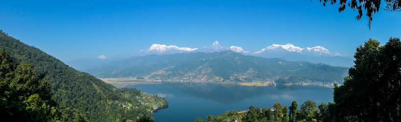 Panoramic view on Phewa Lake from World Peace Pagoda in Pokhara, Nepal. In the back there are high, snow capped Himalayan chains, with Mt Fishtail (Machhapuchhare) between them. Serenity and calmness
