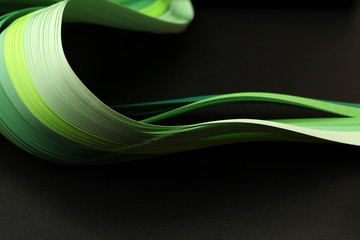 Green color strip wave paper. Abstract texture black background.