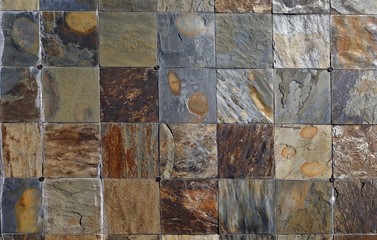 Weathered multicolor slate tiles wall. Background and texture