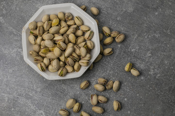 pistachio nuts in a wooden bowl