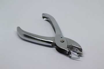 Silver staple remover isolated on white background.