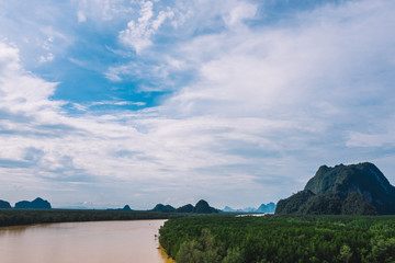 Fototapeta premium Aerial scenery view of mangroves forest, river canals and mountains. Bird's eye view of beautiful panoramic nature landscape of tropical water jungle on Ao Phang Nga bay National Park, Thailand