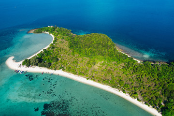 Aerial scenery of picturesque island with crystal azure water and green vegetation.Bird's eye view of paradise beach shoreline, beautiful tourist destination for summer vacations, sport attractions