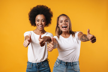 Multiracial girls friends showing thumbs up gesture