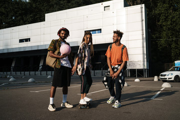 Teenage positive african friends walking
