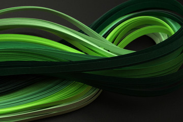 Green color strip wave paper. Abstract texture black background.