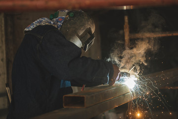 El Oro / Ecuador - 2017 : A welder at his job, welding metal bars together