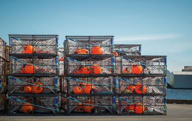 commercial crab fishing pots, traps stacked on the dock