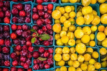 Red and yellow fruit in baskets at farmers market