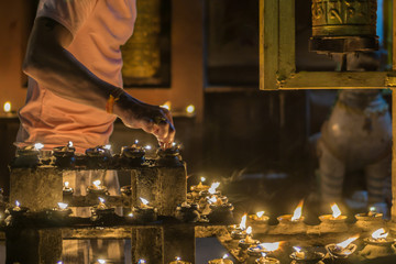 Man lights candles at traditional festival in South Asia