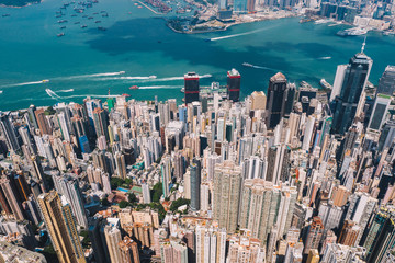 Obraz premium Aerial scenery panoramic view from drone of Hong Kong skyscrapers skyline with metropolitan bay. Modern concrete cityscape of urban downtown with business and financial buildings. City infrastructure