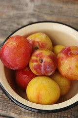 Juicy seasonal plums on the table macro