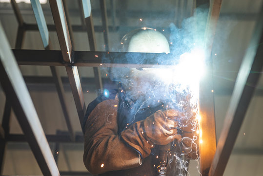 El Oro / Ecuador - 2017 : A welder at his job, welding metal bars together