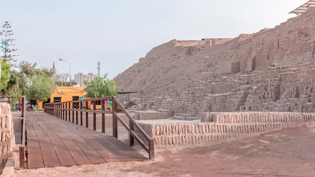 Pyramid of Huaca Pucllana timelapse, pre Inca culture ceremonial building ruins in Lima, Peru. Wooden footbridge and green trees.