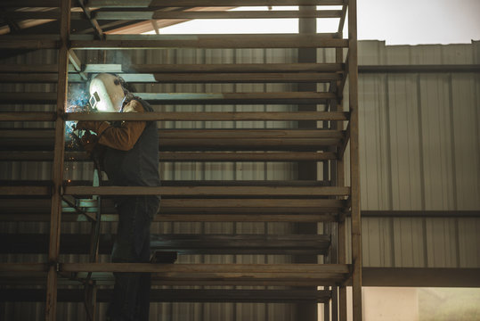 El Oro / Ecuador - 2017 : A welder at his job, welding metal bars together