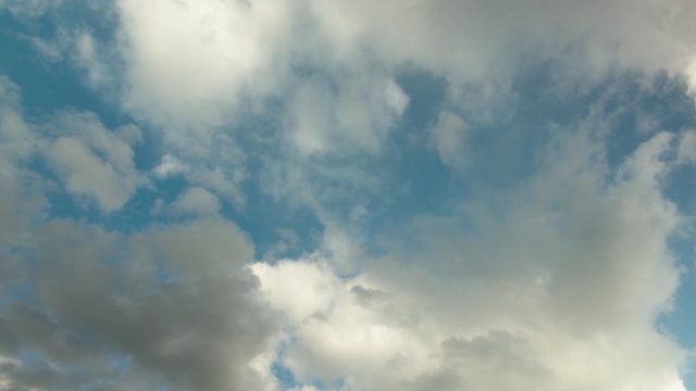 Clouds passing by in the sky at the normal speed.