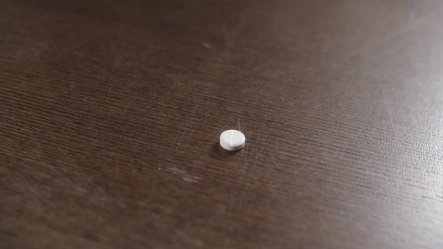Person taking out a single pill from medical package.
