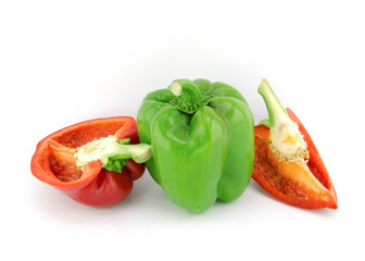 Green and red bell peppers cut into pieces, placed on white.