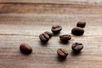 Roasted coffee beans on wooden table background with copy space.