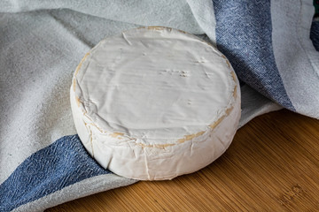 Fresh french brie cheese on wooden board