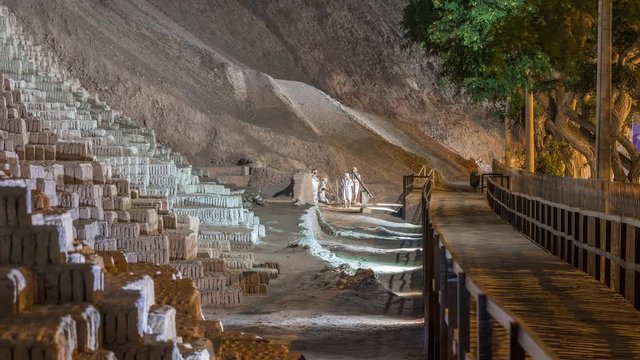 Pyramid of Huaca Pucllana night timelapse, pre Inca culture ceremonial building ruins in Lima, Peru. Wooden footbridge on a side going to sculptures