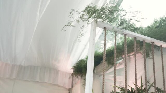 white wedding canopy blowing in the wind