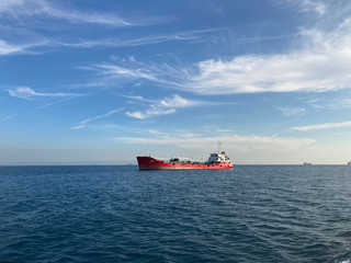 Fototapeta premium cargo ship on sea with amazing blue sky