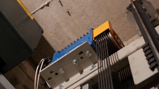 Elevator lift cabin moves up inside illuminated elevator shaft with hydraulics with many floors slow motion