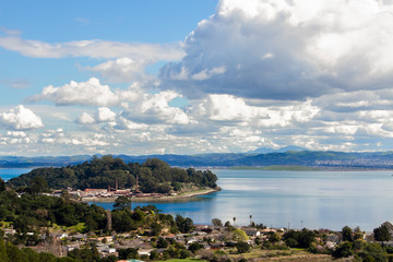 Massive clouds sweep through blue skies over the San Rafael Bay section of San Francisco Bay with...