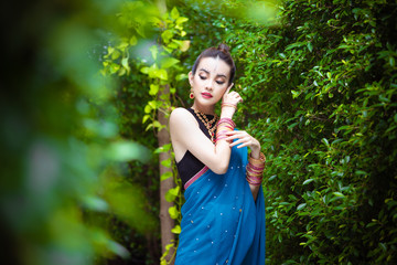 Portrait of young asian girl with kundan jewelry set and traditional hindu Indian costume saree and lehenga dress model