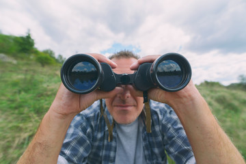  Man looking through binocular