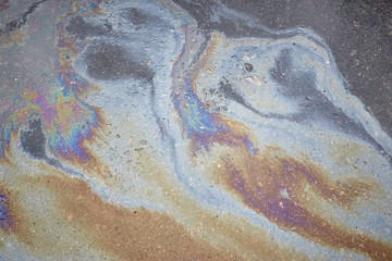 Oil slick on the asphalt road background