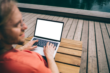 Male freelancer working on pier