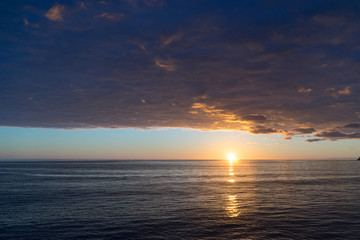Seascape at sunset with heavy storm clouds