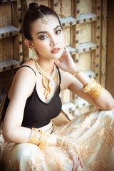 Portrait of young asian girl with kundan jewelry set and traditional hindu Indian costume saree and lehenga dress model