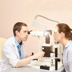 Eye doctor exam patient pressure heath. ophthalmology concept. astigmatism diagnosis at clinic....