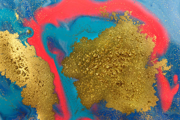 Fototapeta na wymiar Piles of gold sequins on pink smudges of paint. Abstract pattern.