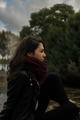 girl sitting on a pier looking at nature, trees, relax concept, vacation advertising, travel campaign