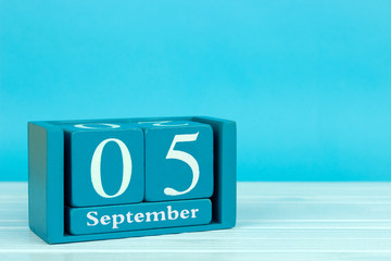 wooden calendar with the date of August 5 on a blue wooden background, International Beard Day,...