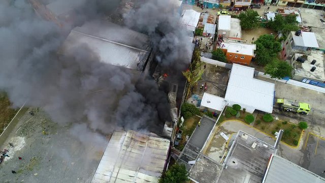 Aerial view of a burning building, aftermath of a explosion, smoke rising, in Jerusalem, Israel - rising, pull back, drone shot