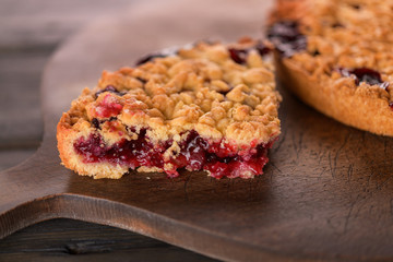 Round cake with berry filling on a wooden background