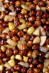 Pear and hazelnut in syrup. Process of cooking jam. Food texture